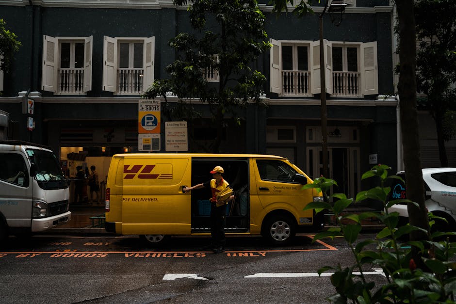 A floral delivery scene featuring a person wearing a yellow and red uniform loading flowers into a yellow DHL delivery van parked on a wet street in front of a building with open white shuttered windo